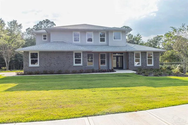 a front view of a house with a garden