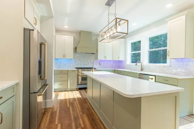 a kitchen with a stove top oven sink and cabinets