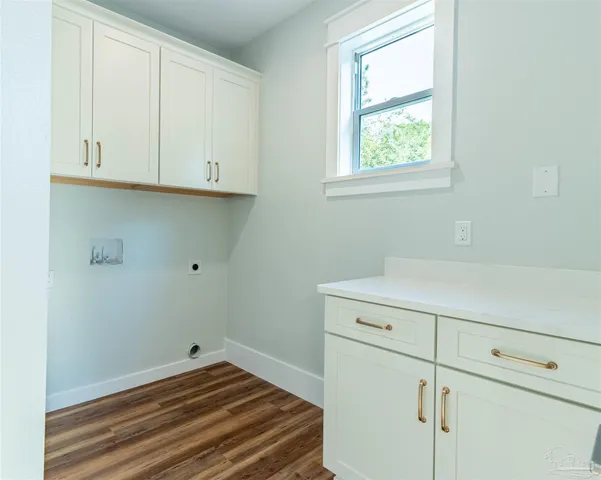 a view of a big room with wooden floor and a chandelier fan