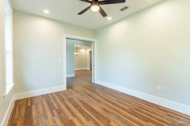 wooden floor in an empty room with a window