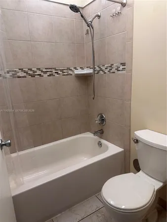a white toilet sitting next to a bath tub