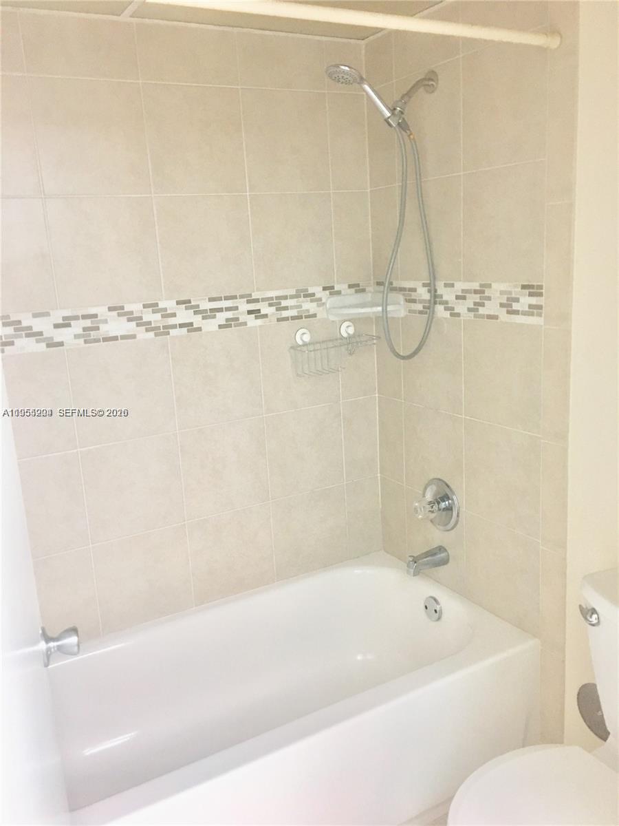10875 Southwest 112th Avenue, Unit 104 Miami, FL 33176 - Photo 10 of 11 a bathroom with a bathtub and a shower