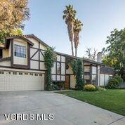 19620 Leadwell Street Reseda, CA 91335 - Photo 1 of 28 a view of a blue house with a yard and a fountain