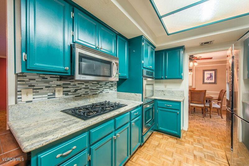 19620 Leadwell Street Reseda, CA 91335 - Photo 11 of 28 a kitchen with cabinets a sink and appliances