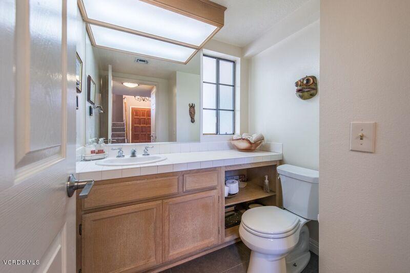 19620 Leadwell Street Reseda, CA 91335 - Photo 12 of 28 a bathroom with a sink a toilet and mirror