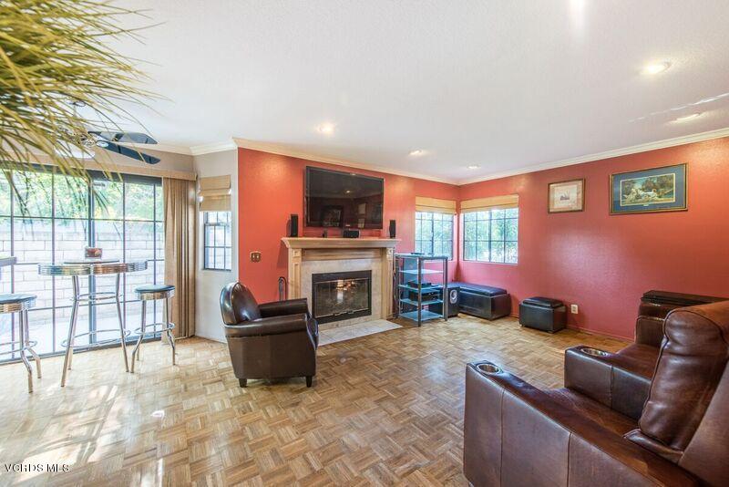 19620 Leadwell Street Reseda, CA 91335 - Photo 14 of 28 a living room with furniture a fireplace and a flat screen tv