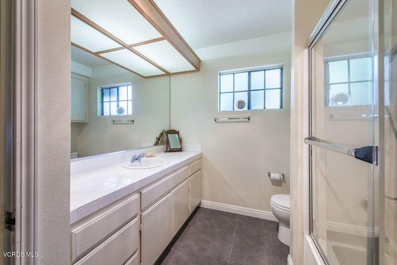19620 Leadwell Street Reseda, CA 91335 - Photo 19 of 28 a bathroom with a sink a toilet and shower