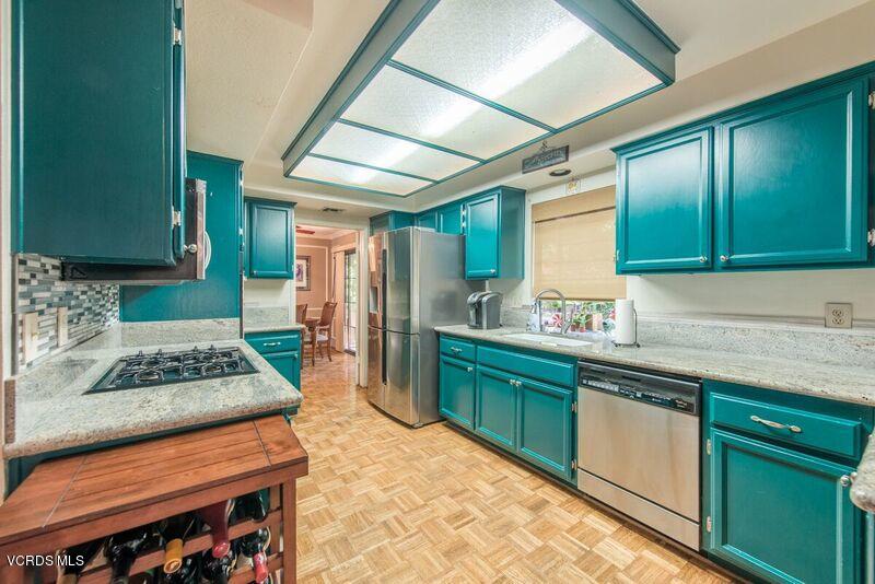 19620 Leadwell Street Reseda, CA 91335 - Photo 10 of 28 a kitchen with stainless steel appliances granite countertop a sink stove and cabinets