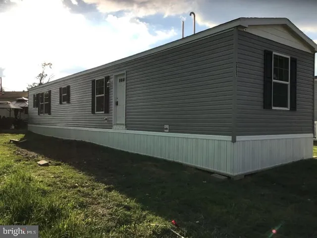 a back view of a house with a yard