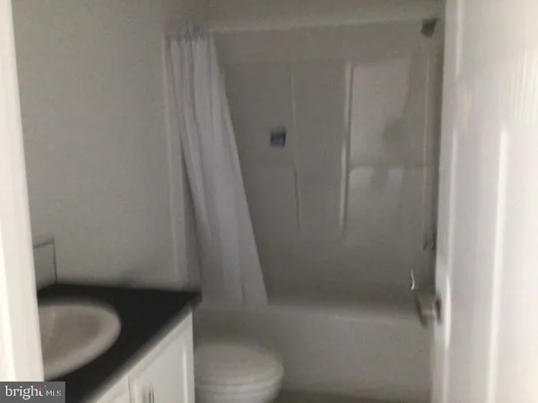 a bathroom with a granite countertop sink