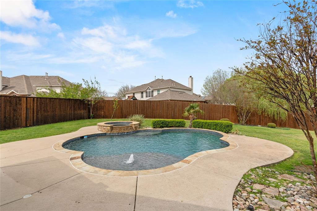 a view of a swimming pool with a yard