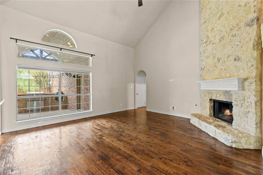 613 Windward Drive Murphy, TX 75094 - Photo 12 of 37 wooden floor fireplace and windows in an empty room
