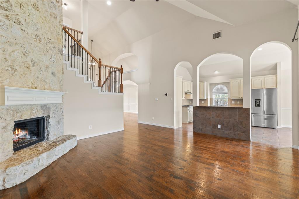 613 Windward Drive Murphy, TX 75094 - Photo 15 of 37 a view of a livingroom with wooden floor and a fireplace