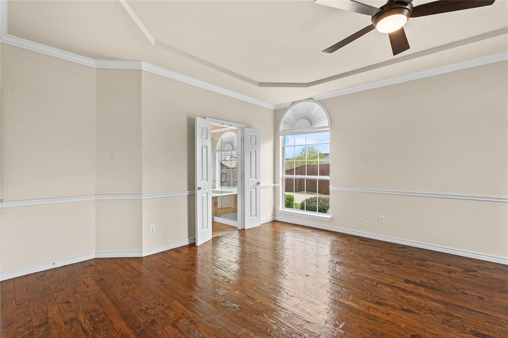 613 Windward Drive Murphy, TX 75094 - Photo 22 of 37 a view of an empty room with a window and wooden floor
