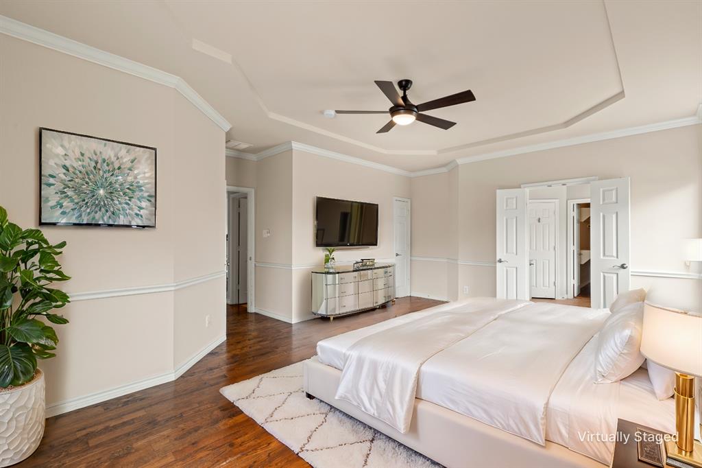 613 Windward Drive Murphy, TX 75094 - Photo 24 of 37 a bedroom with a bed and a flat screen tv