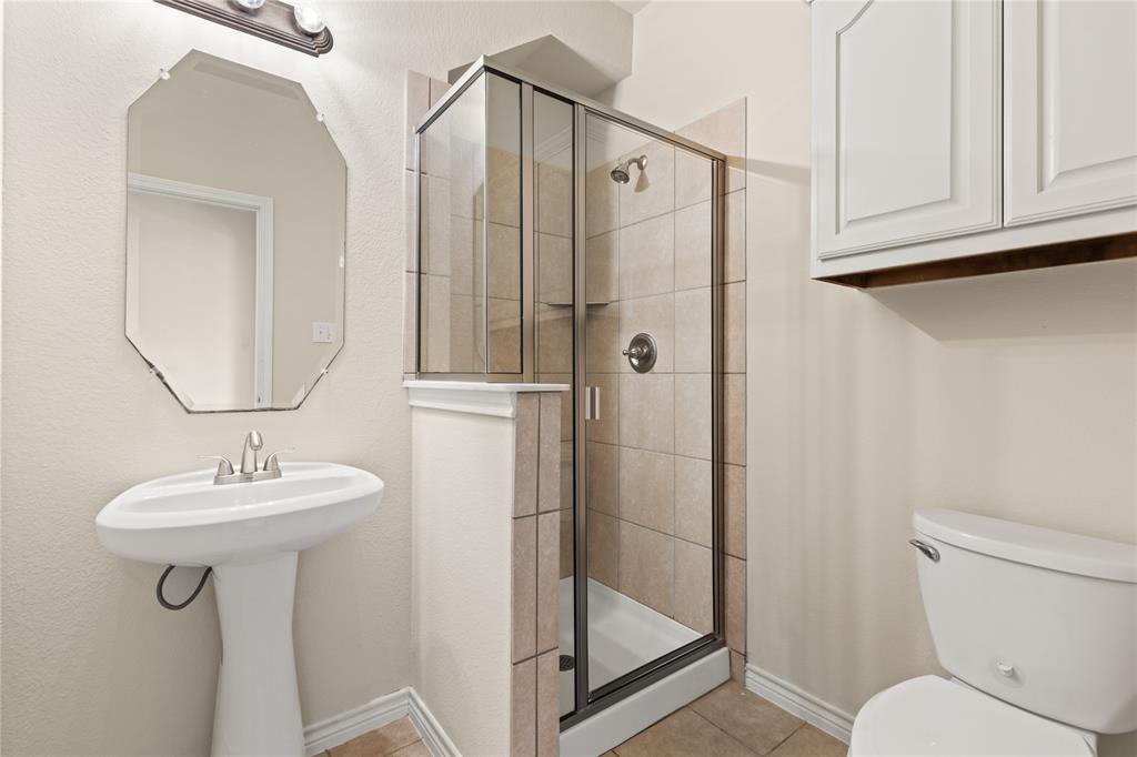 613 Windward Drive Murphy, TX 75094 - Photo 27 of 37 a bathroom with a sink toilet and shower