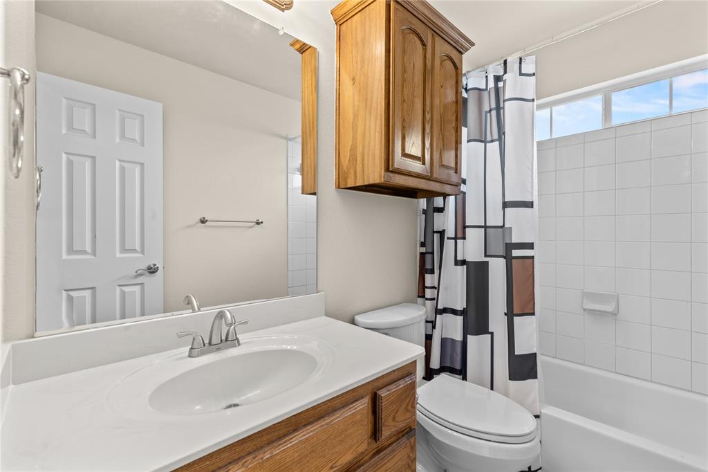 613 Windward Drive Murphy, TX 75094 - Photo 32 of 37 a bathroom with a sink a toilet and shower
