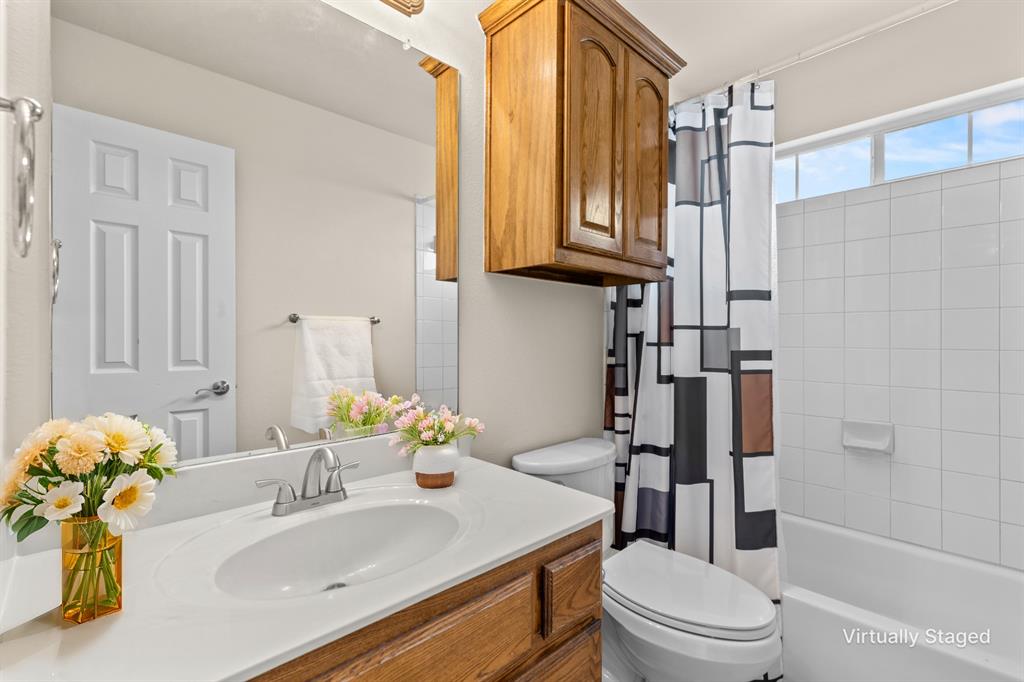 613 Windward Drive Murphy, TX 75094 - Photo 33 of 37 a bathroom with a sink a toilet and shower