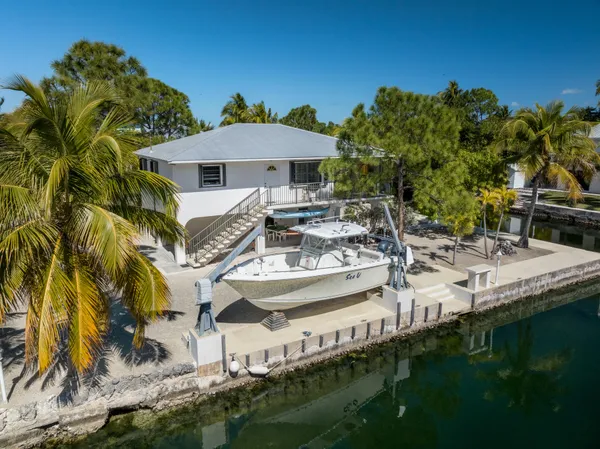 a view of house with yard and sitting area