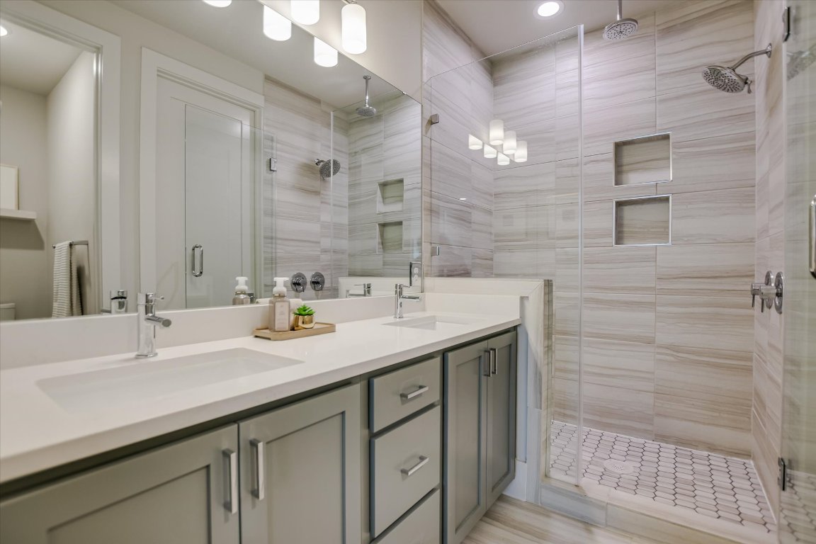 5212 Pink Poppy Pass, Unit 20 Austin, TX 78735 - Photo 12 of 24 Full bathroom featuring double vanity, a shower stall, and recessed lighting
