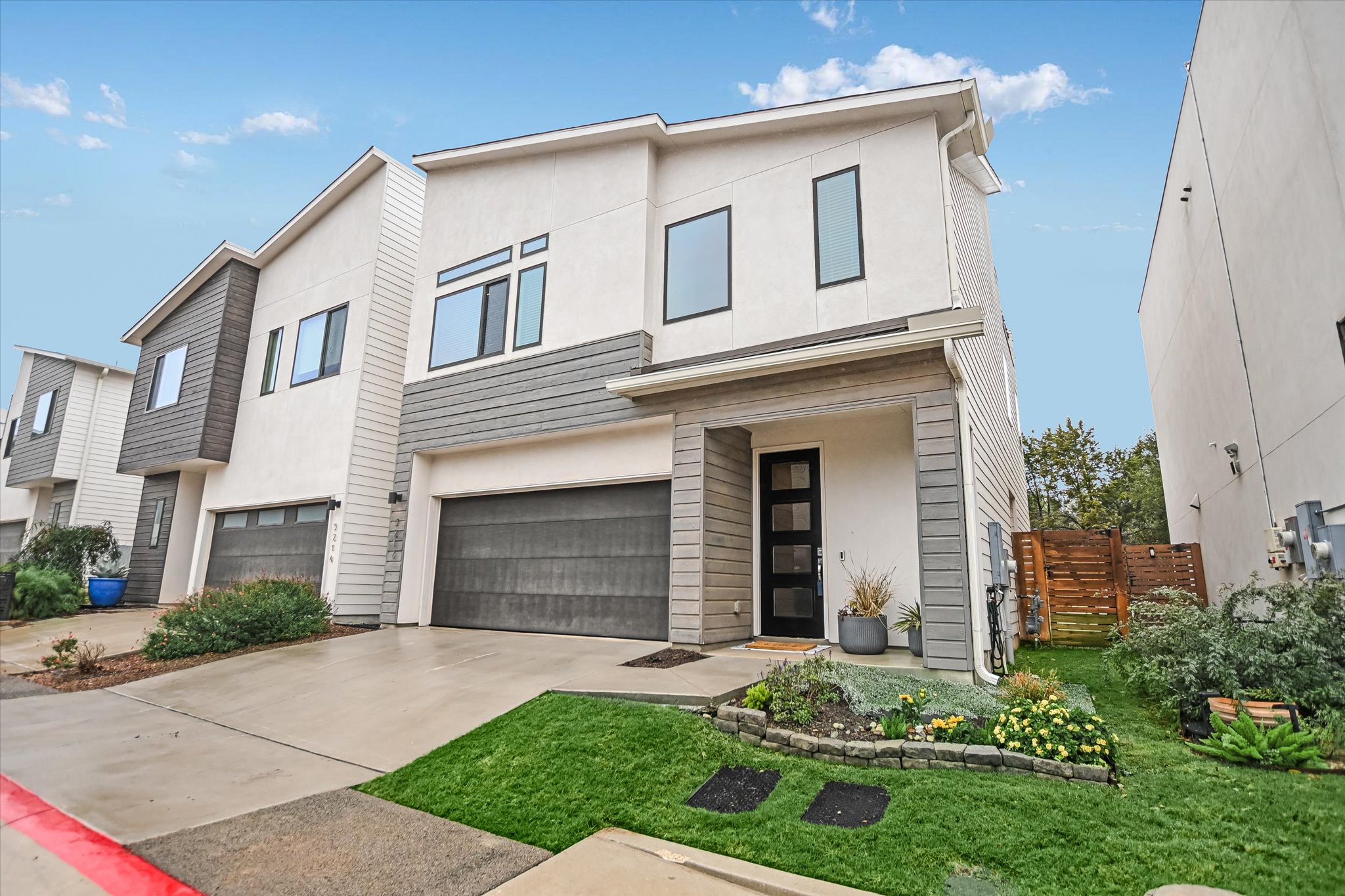 5212 Pink Poppy Pass, Unit 20 Austin, TX 78735 - Photo 3 of 24 Modern home with stucco siding, driveway, and a garage