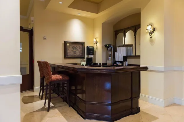a living room with table chairs and wooden floor
