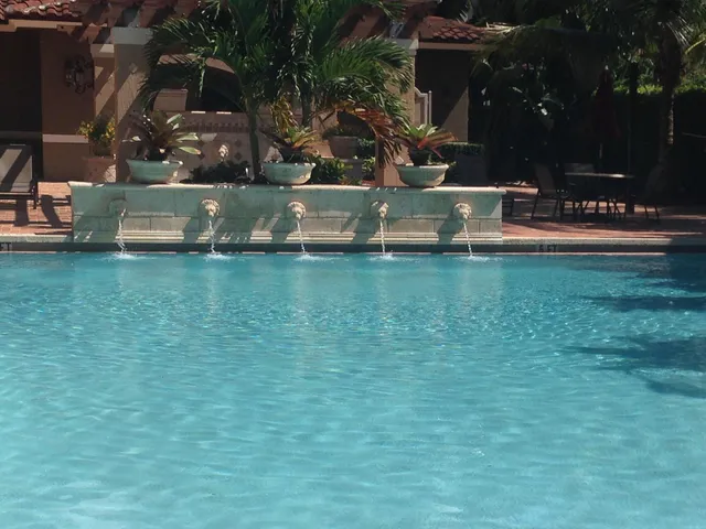 a view of swimming pool with outdoor seating and green field