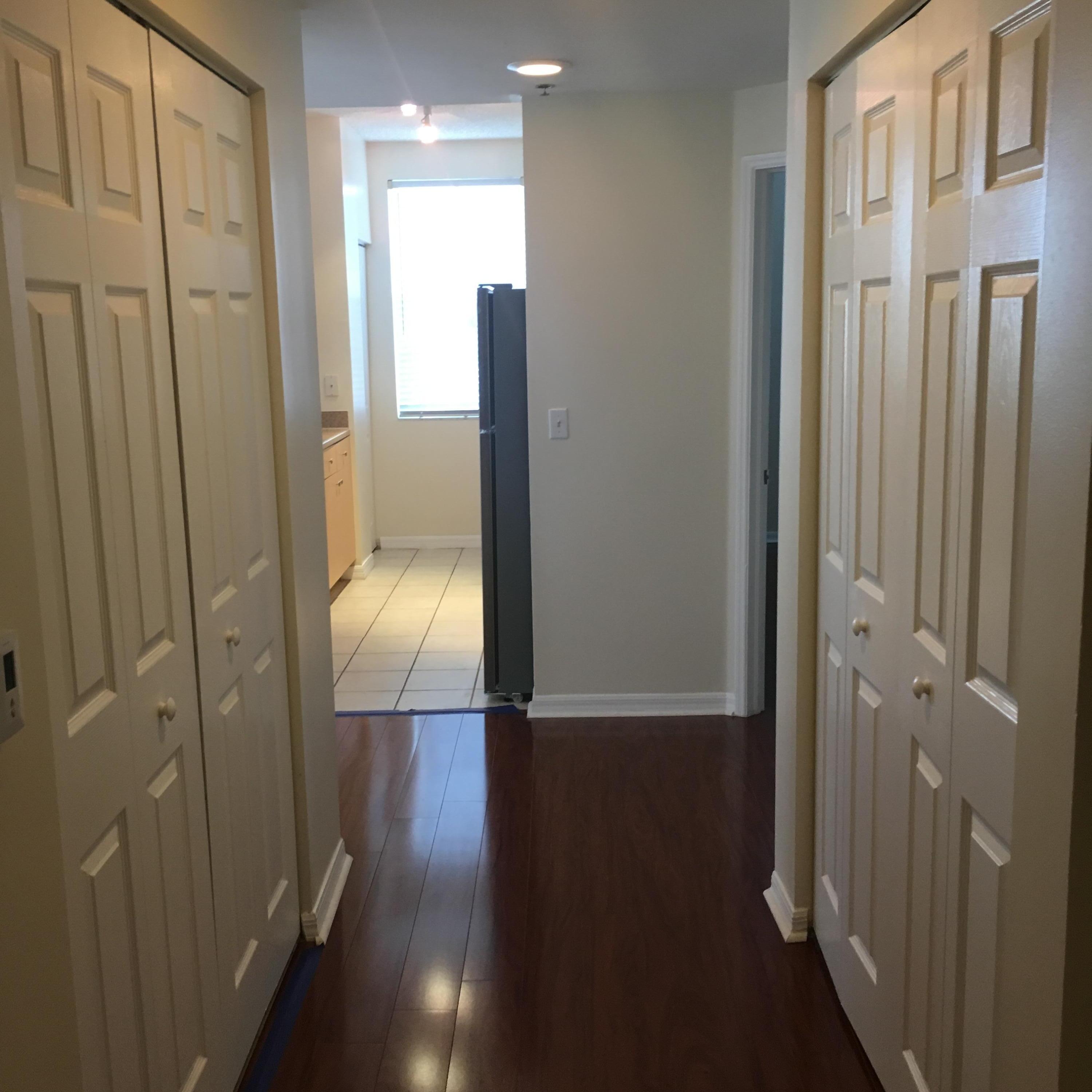616 Clearwater Park Road, Unit 413 West Palm Beach, FL 33401 - Photo 2 of 21 a view of hallway with wooden floor