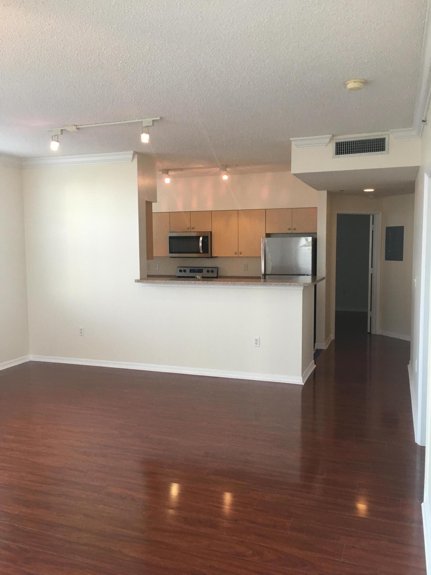 616 Clearwater Park Road, Unit 413 West Palm Beach, FL 33401 - Photo 3 of 21 a view of a kitchen with a sink and a microwave