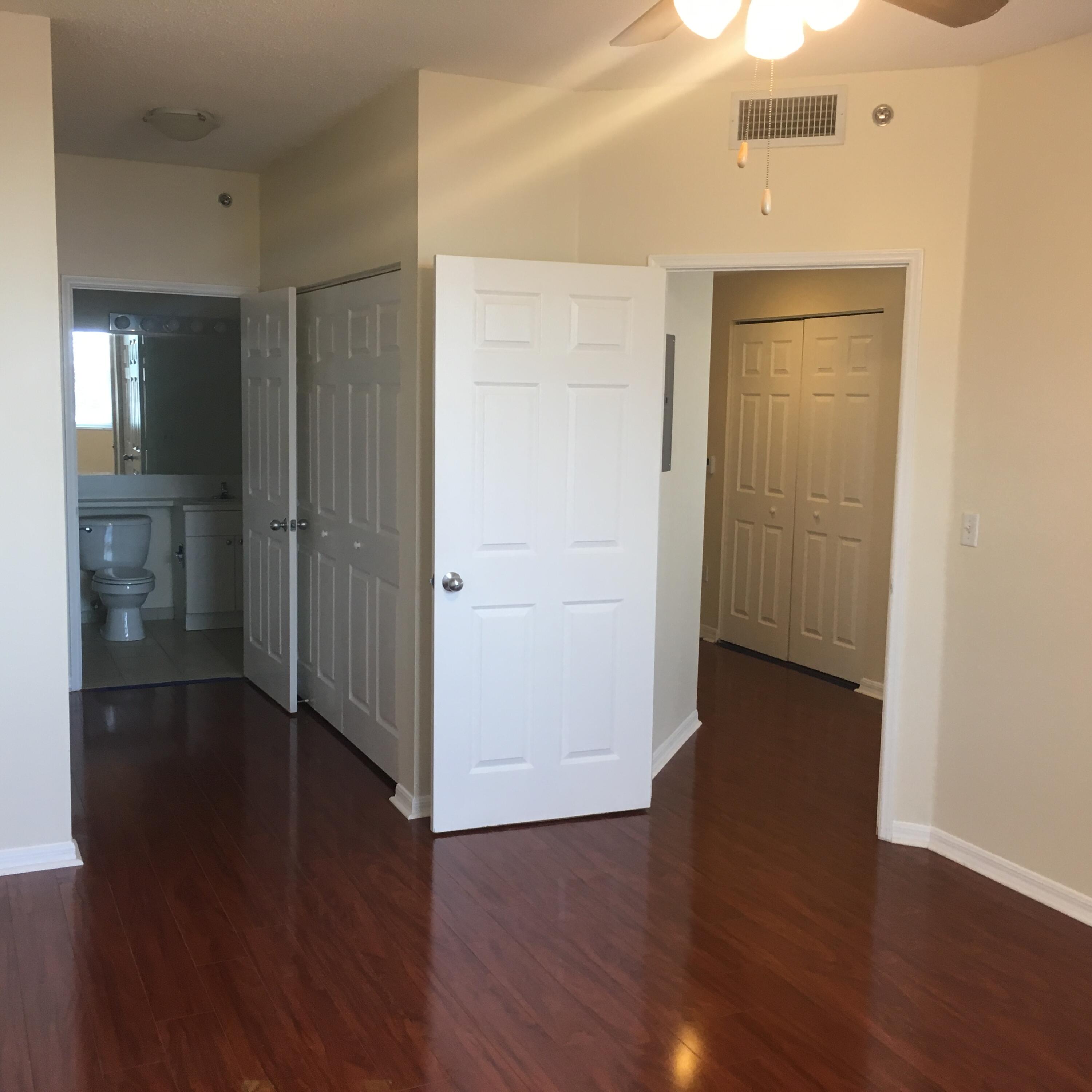616 Clearwater Park Road, Unit 413 West Palm Beach, FL 33401 - Photo 5 of 21 an empty room with wooden floor & closet area