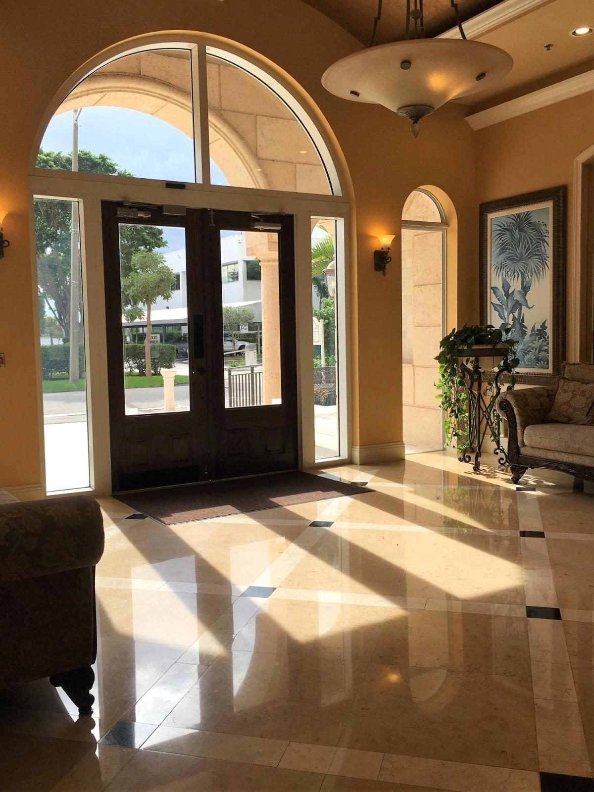 616 Clearwater Park Road, Unit 413 West Palm Beach, FL 33401 - Photo 10 of 21 a living room with large windows