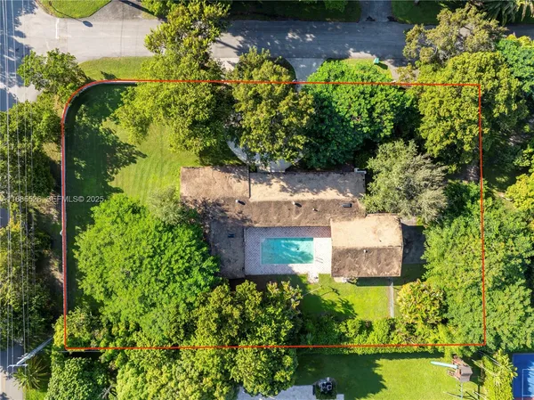 an aerial view of a house with a yard and garden