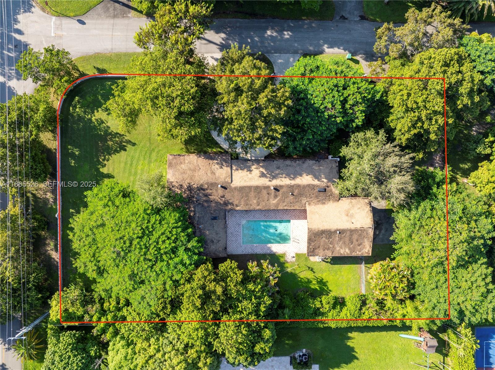 an aerial view of a house with a yard and garden