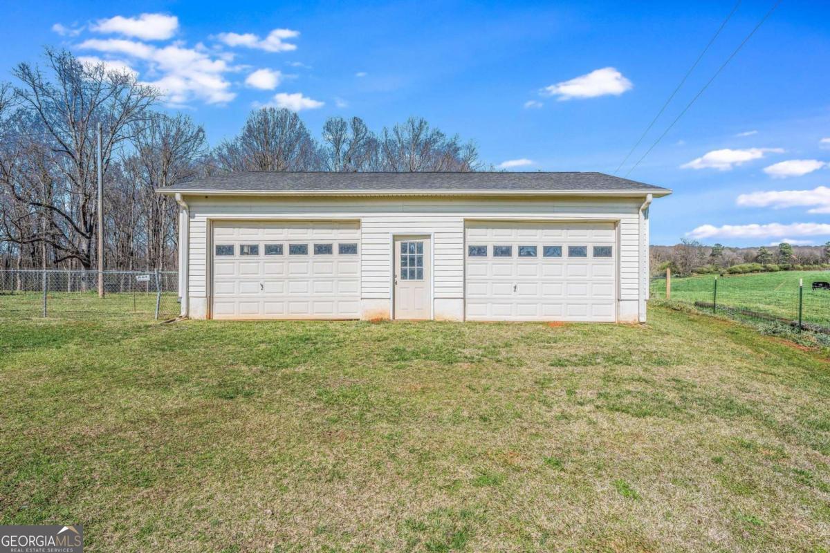 417 Pulliam Lane Royston, GA 30662 - Photo 23 of 27 a view of a big building with big yard and large trees