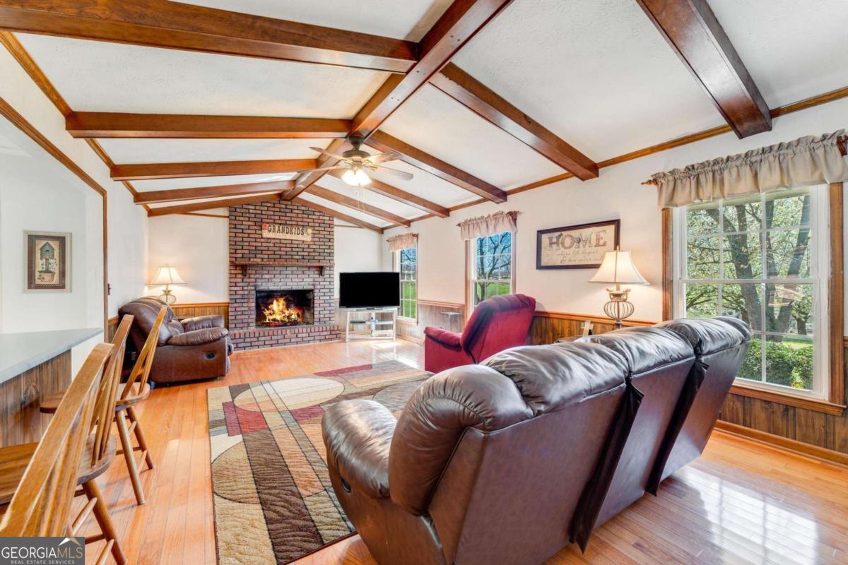 417 Pulliam Lane Royston, GA 30662 - Photo 4 of 27 a living room with furniture a fireplace and wooden floor