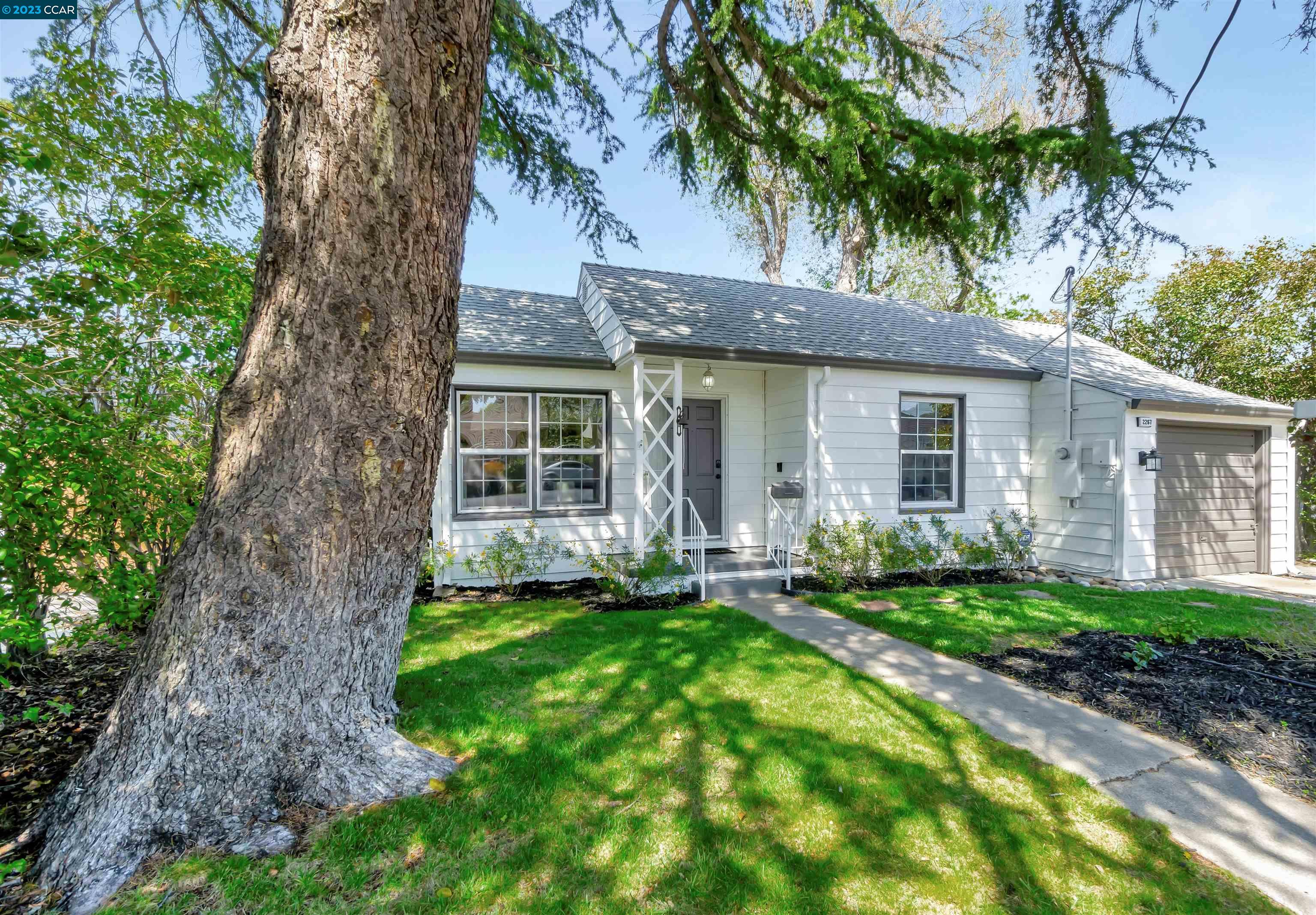 a front view of a house with a garden