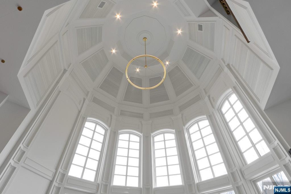 10 Frick Drive Alpine, NJ 07620 - Photo 12 of 28 a large room with a large window and chandelier