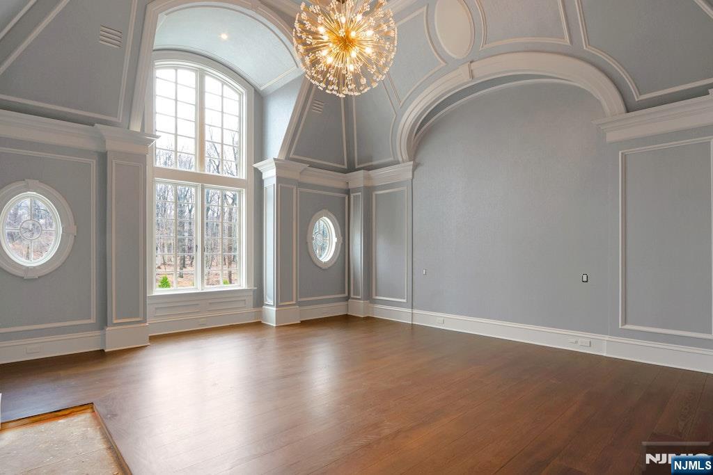 10 Frick Drive Alpine, NJ 07620 - Photo 16 of 28 an empty room with wooden floor and windows