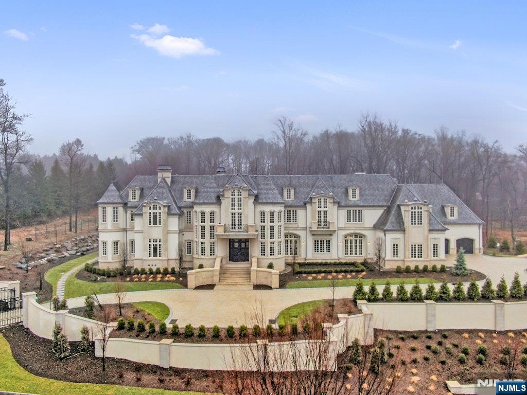 10 Frick Drive Alpine, NJ 07620 - Photo 2 of 28 a front view of a house with a swimming pool