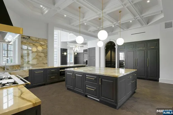 a large kitchen with granite countertop a stove and a sink