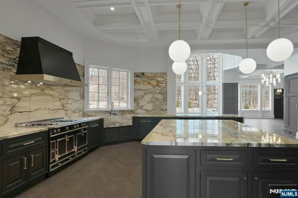 a large kitchen with a stove and a sink