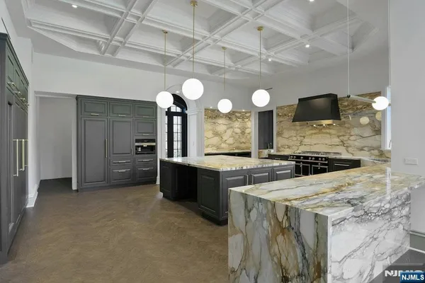 a kitchen with a counter space and a view of living room