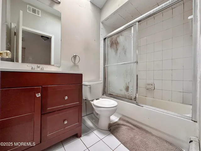 a bedroom with a bed couch and a window