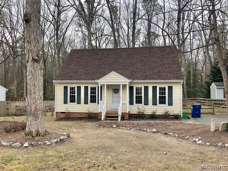 a house that has a tree in front of it