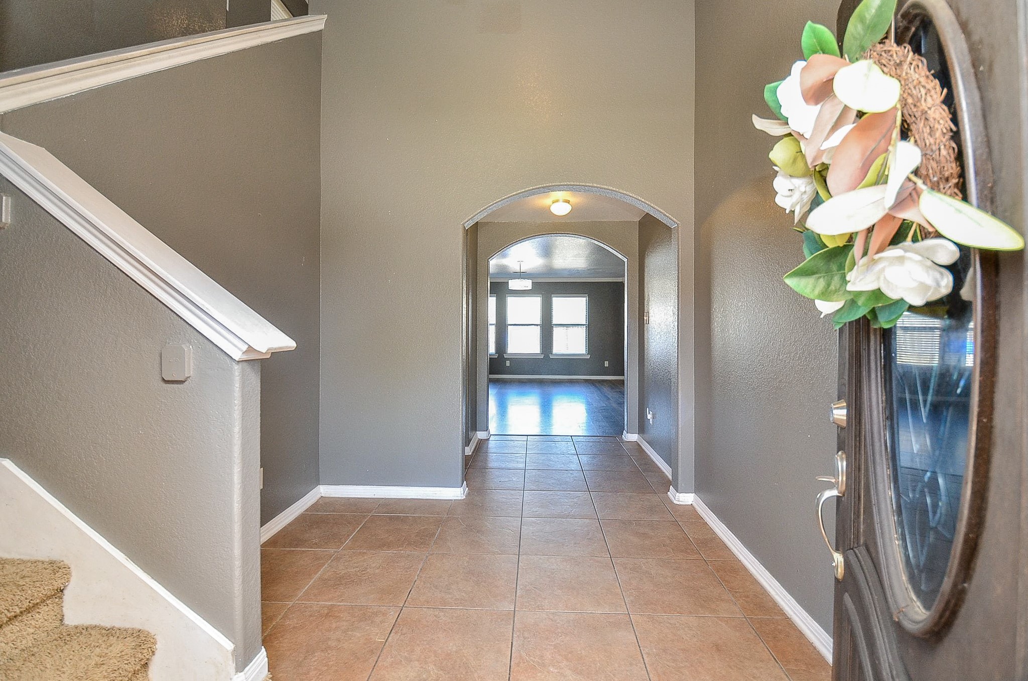 5411 Rio Drive Baytown, TX 77521 - Photo 6 of 30 Warm tile flooring and neutral walls greet you upon entry. Your options are to turn left and head upstairs to your bedroom retreats or continue into the spacious living area to relax.