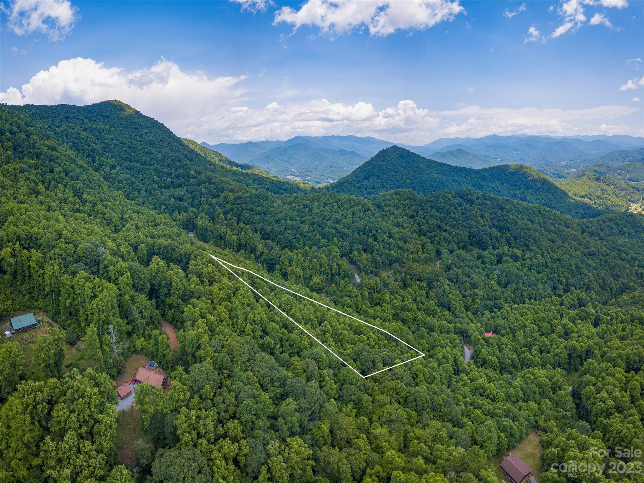 Lot 16 Lanterns Wick Trail Sylva, NC 28779 - Photo 7 of 8 a view of a lush green hillside and a mountain