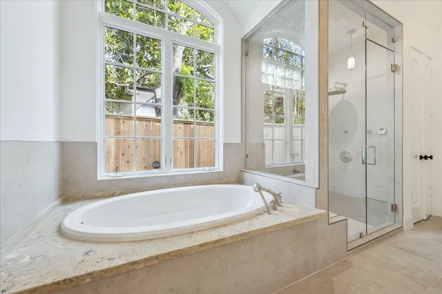 a white bath tub sitting next to a shower