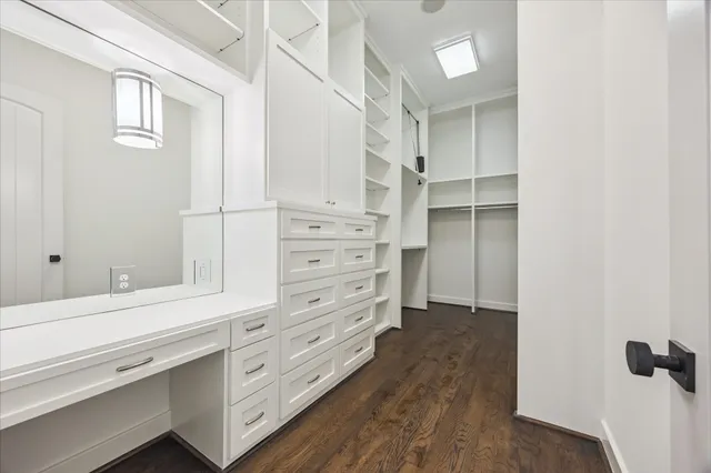 a view of walk in closet with empty racks