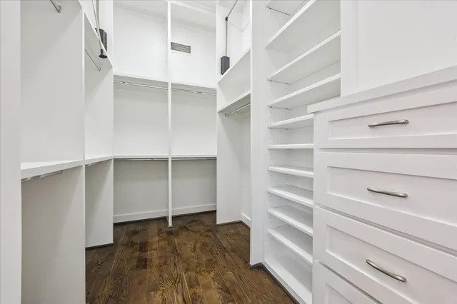 a view of walk in closet with empty racks