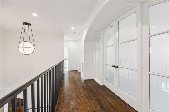 a view of a hallway with wooden floor